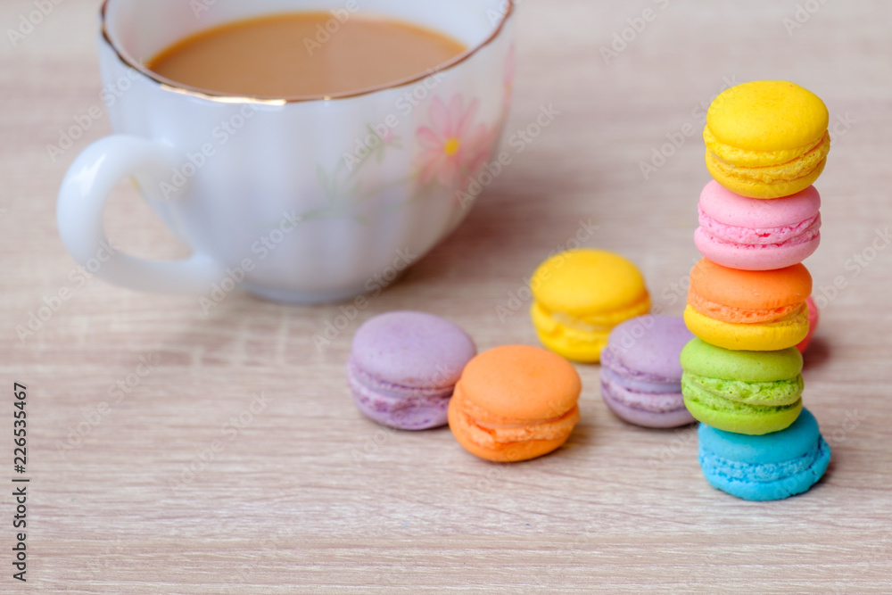 Macaron dessert and coffee on the wooden table. Macaron dessert and coffee on the wooden table.