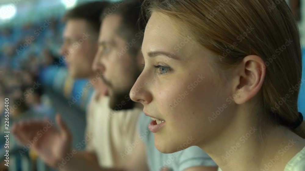 Girl chanting and applauding at sport event, leisure activity with friends Girl chanting and applauding at sport event, leisure activity with friends