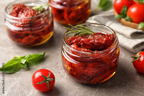 Dried tomatoes in glass jar on table. Healthy snack