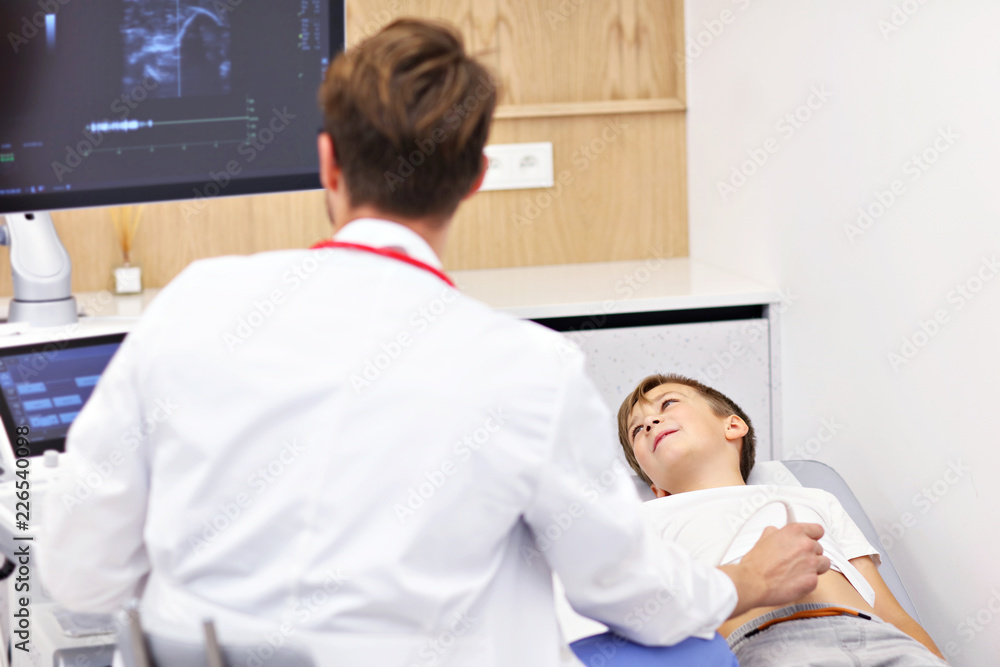 Doctor testing young boy with usg Doctor testing young boy with usg
