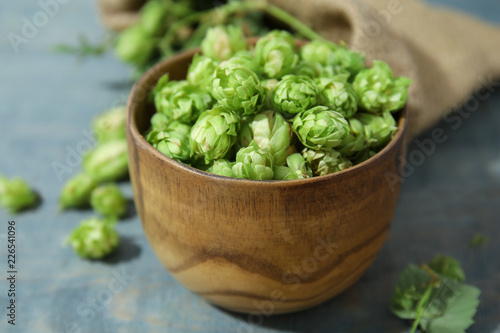 Bowl with fresh green hops on wooden table. Beer production