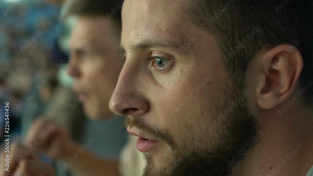 Closeup of spectator roaring at stadium, frustrated with defeat, slow-motion