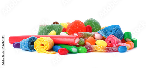Pile of delicious colorful chewing candies on white background