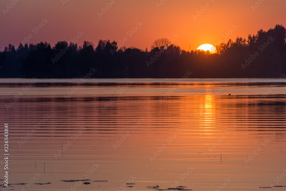 Naklejka premium Sun is going down by the lake