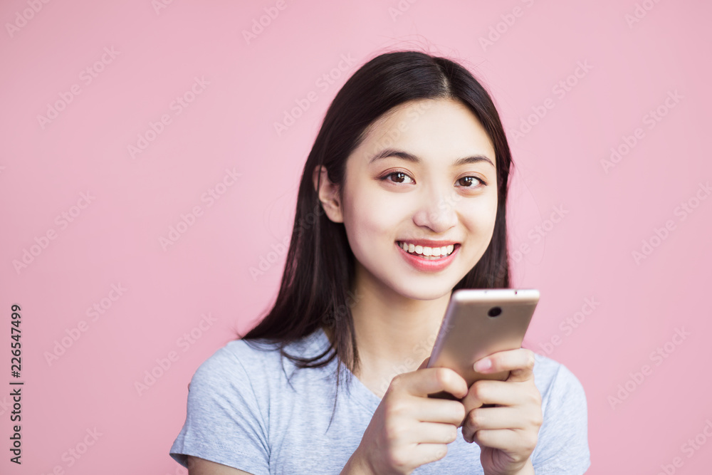 A cheerful woman holds the phone close to her face, looks into the camera and laughs because she saw something funny, joyous in the screen of her phone, what she likes A cheerful woman holds the phone close to her face, looks into the camera and laughs because she saw something funny, joyous in the screen of her phone, what she likes