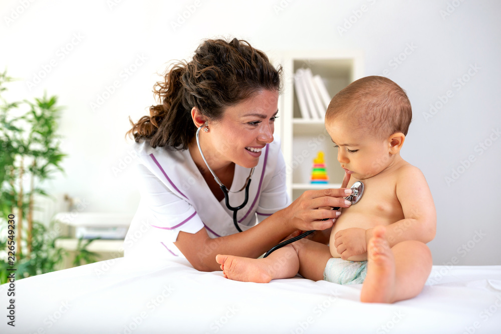 Physician examining her baby patient Physician examining her baby patient