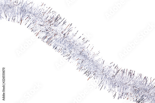 Silver tinsel on white background. Silver shiny Christmas garland isolated on white background, diagonal position. Beautiful decoration on Christmas holiday. photo