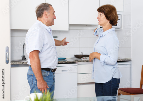 Unhappy mature couple discussion together  quarrel in home interior