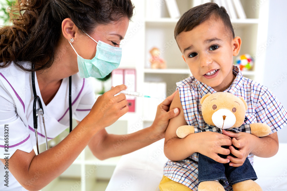 Child receiving a vaccine dose - obrazy, fototapety, plakaty 