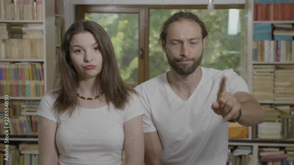 Young couple of man and woman doing no gesture with index finger refusing proposal expressing disagreement Young couple of man and woman doing no gesture with index finger refusing proposal expressing disagreement