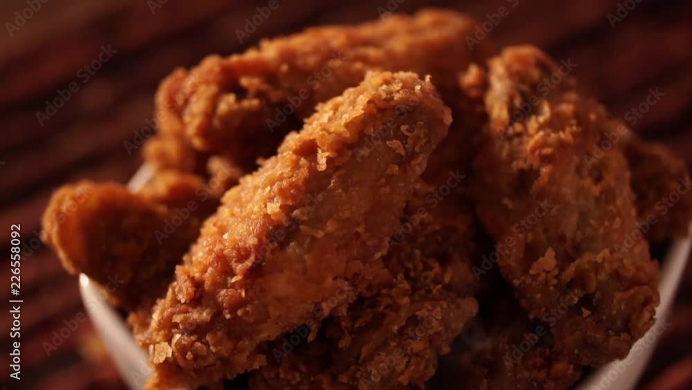 Rotation Bucket full of crispy kentucky fried chicken with smoke on brown background. Rotation Bucket full of crispy kentucky fried chicken with smoke on brown background.