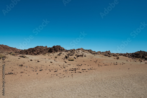 desert landscape - sand, rocks and clear blue sky copy space 
