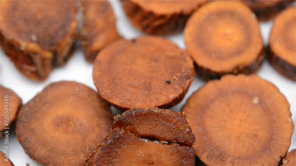 Chinese herb medicine of Glycyrrhiza uralensis or Licorice rotating close up Chinese herb medicine of Glycyrrhiza uralensis or Licorice rotating close up