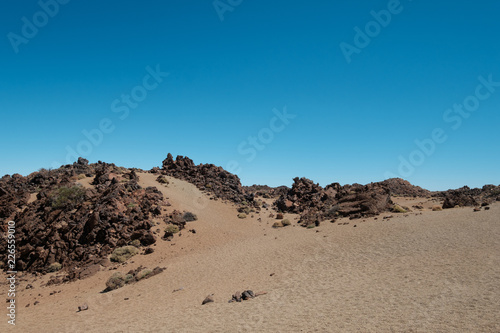 desert landscape with volcanic rocks , blue sky copy space 