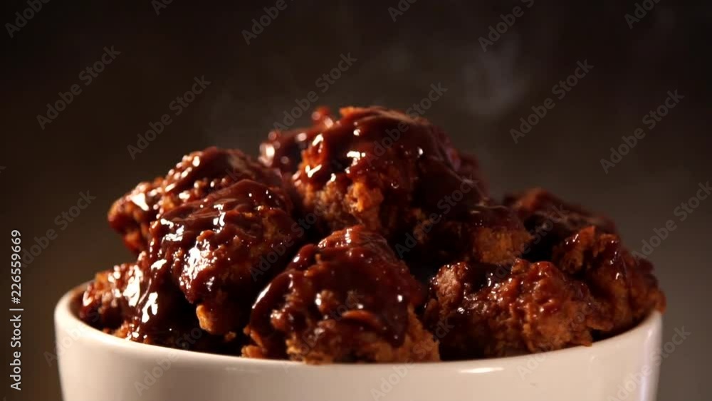 Rotation Bucket full of crispy kentucky fried chicken with smoke on brown background. Rotation Bucket full of crispy kentucky fried chicken with smoke on brown background.
