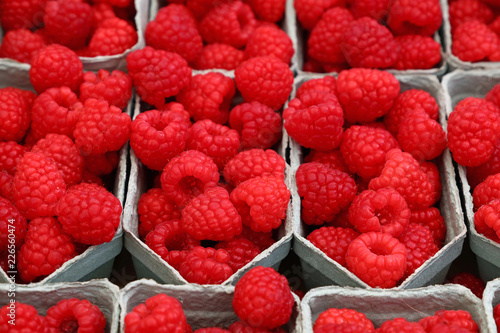 Close up red ripe raspberry on retail display