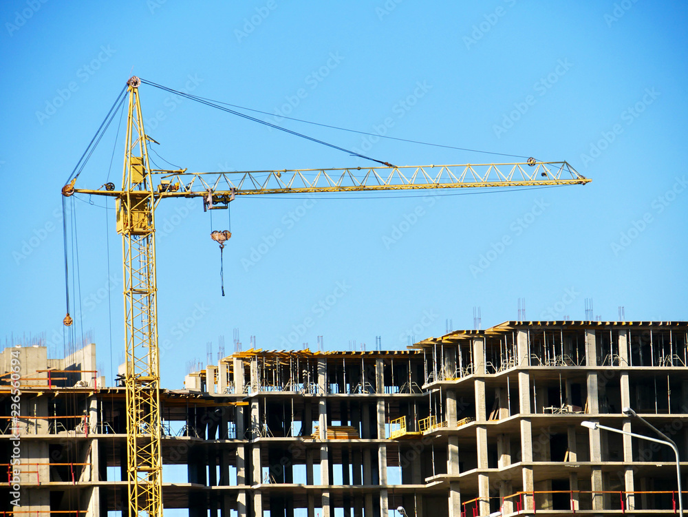 Construction site background. Crane near building. Construction site background. Crane near building.