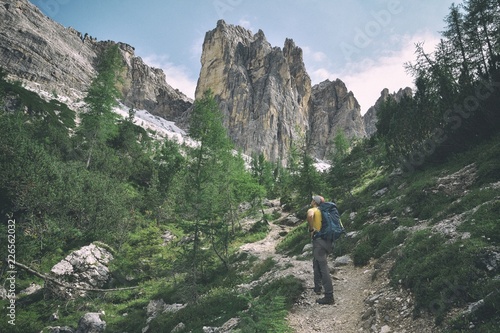 Tourist hiking in Dolomites mountains 