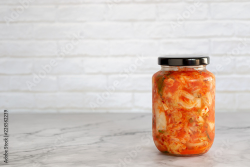 homemade cabbage kimchi in a glass jar photo