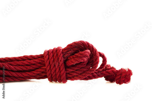 One skein of jute rope six millimeters for Japanese bondage and shibari, painted in red on a white background. Professionally knitted hank