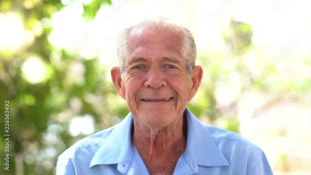 portrait of senior brazilian man with white hat looking at camera and one spot in sunset and smiling. Horizontal shape, copy space portrait of senior brazilian man with white hat looking at camera and one spot in sunset and smiling. Horizontal shape, copy space