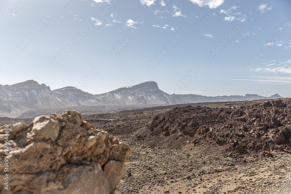 Volcanic rocks and lava mountains in the middle of a desert landscape in the Teide National Park, Canary Islands