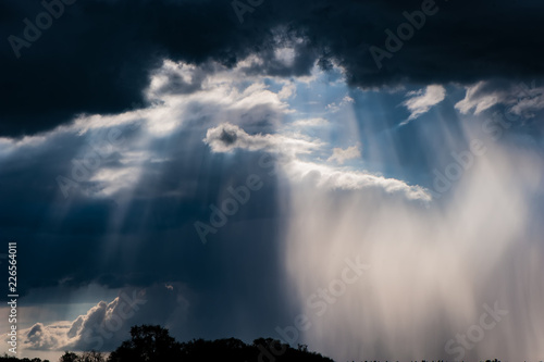 Storm clouds, sunshine and rain in the countryside. © APHOTOSTUDIO