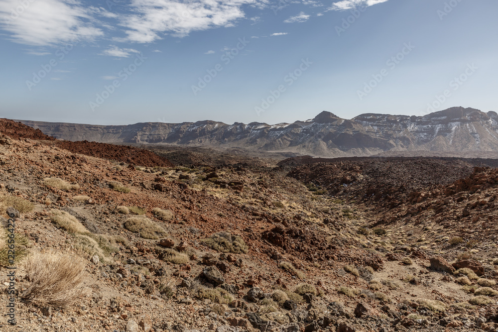 Impressive desert landscape with big mountains in the background on a sunny day on the island of Tenerife