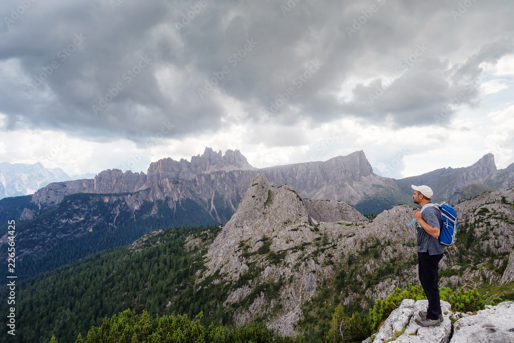 Man admires the mountain landscape of the Alpine peaks. Dolomites