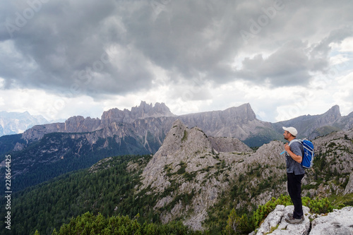 Man admires the mountain landscape of the Alpine peaks. Dolomites