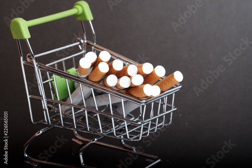 lots of cigarettes stacked in shopping basket filters to us, buying cigarettes wholesale photo