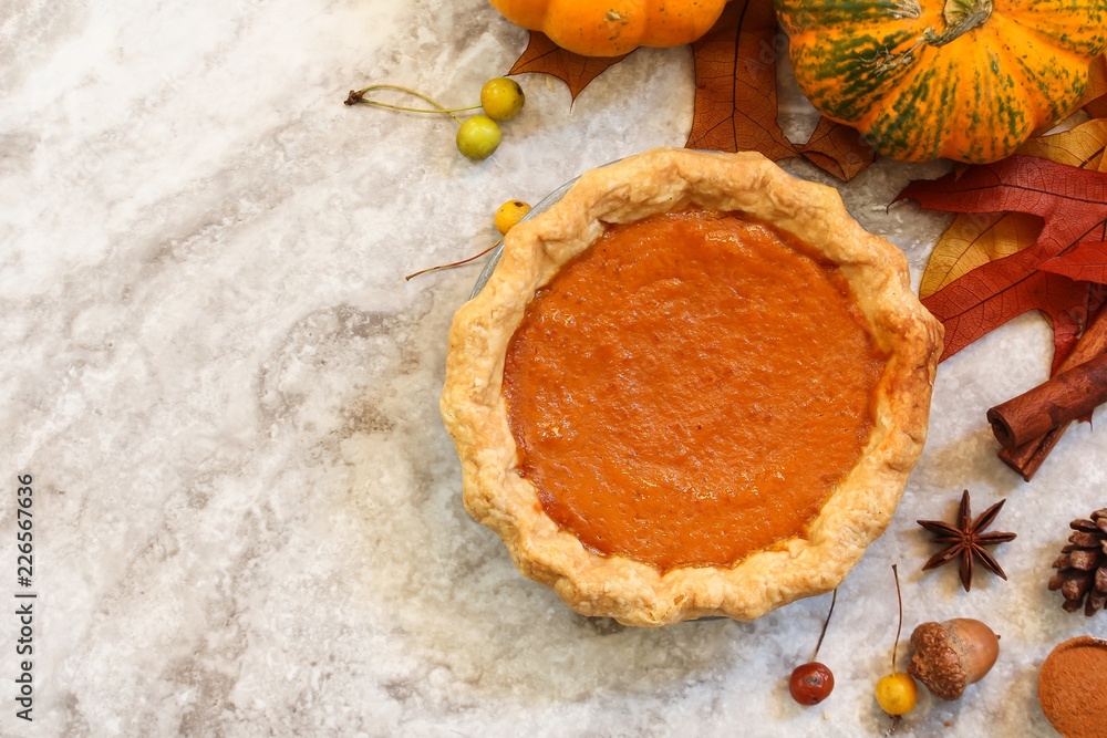 Homemade Pumpkin Pie on Fall Thanksgiving background, top view Homemade Pumpkin Pie on Fall Thanksgiving background, top view