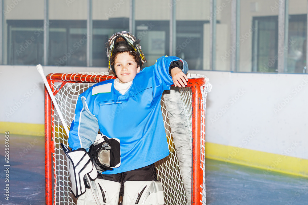 Fototapeta premium Happy boy goaltender posing after hockey match