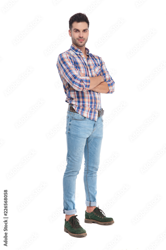 handsome casual man wearing checkers shirt standing with arms folded handsome casual man wearing checkers shirt standing with arms folded