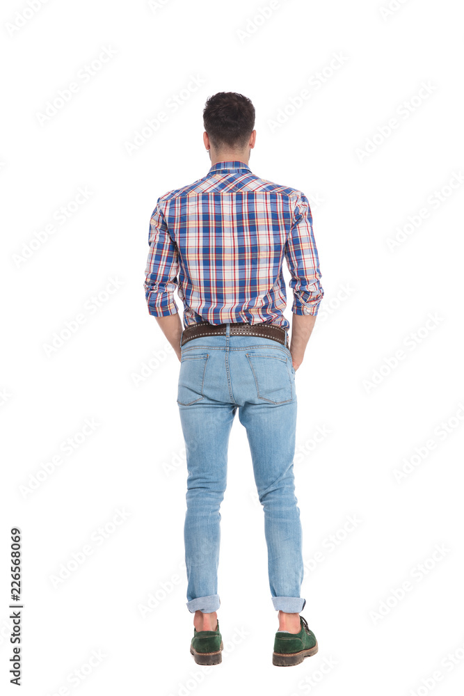 back view of relaxed man wearing shirt with blue checkers back view of relaxed man wearing shirt with blue checkers