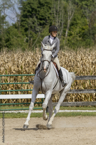 Woman gallops gelding around a corner at show © Leah Smalley 
