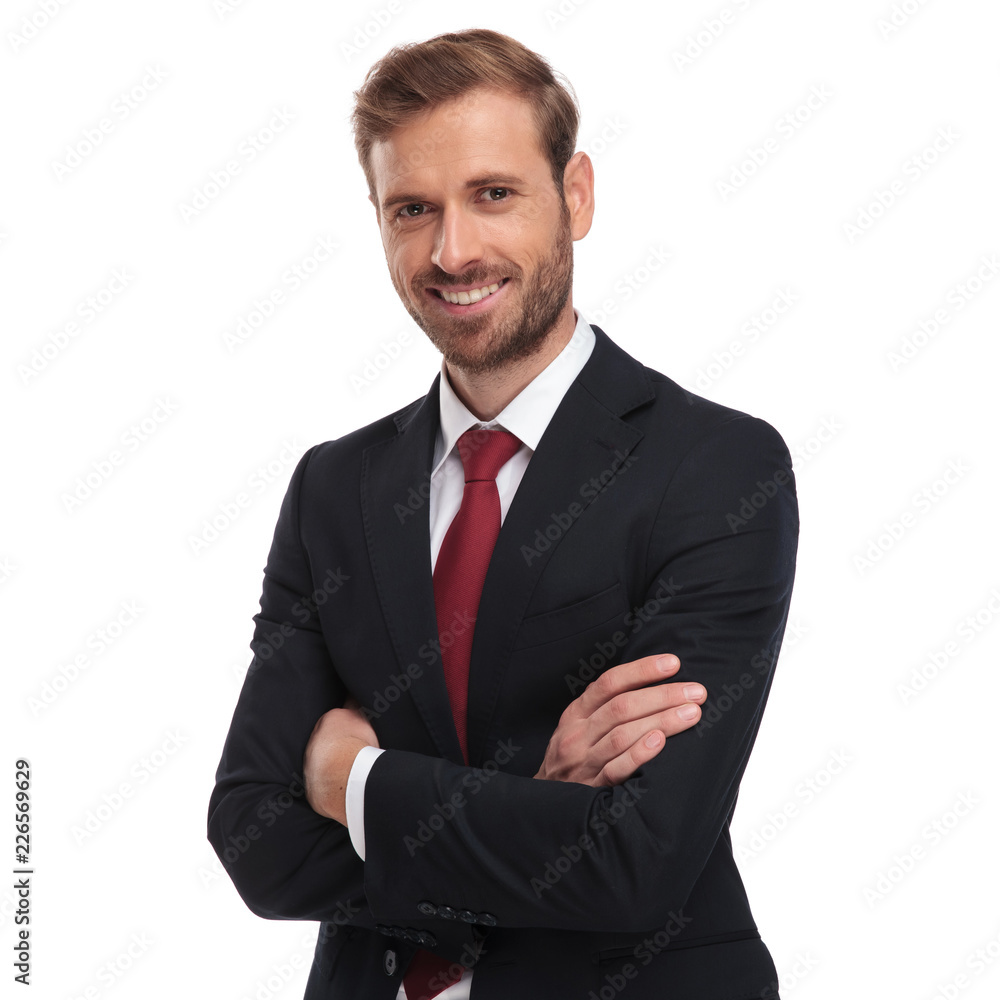 portrait of smiling businessman standing with hands folded - obrazy, fototapety, plakaty 