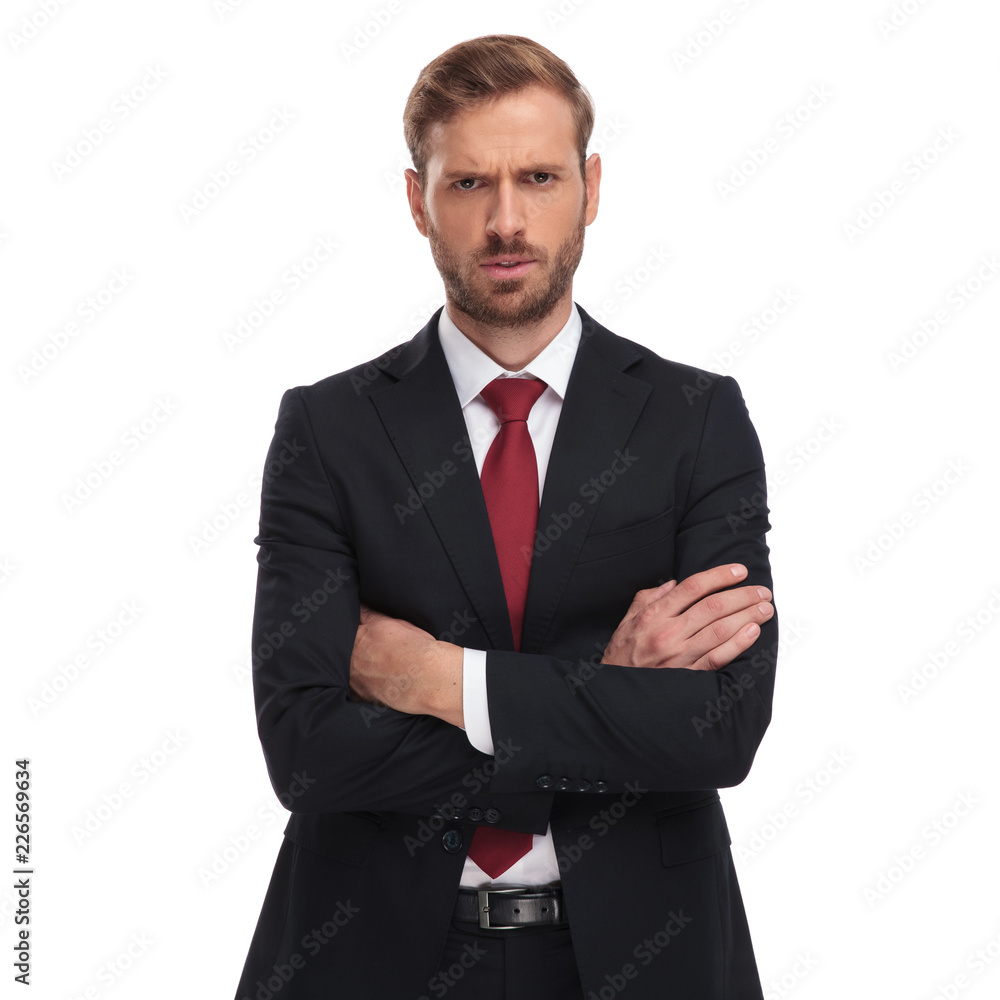 portrait of angry businessman with folded arms standing portrait of angry businessman with folded arms standing
