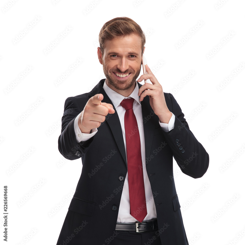 laughing businessman speaks on phone and points finger laughing businessman speaks on phone and points finger