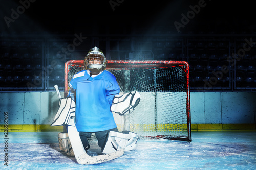 Young goaltender guards his net during hockey game
