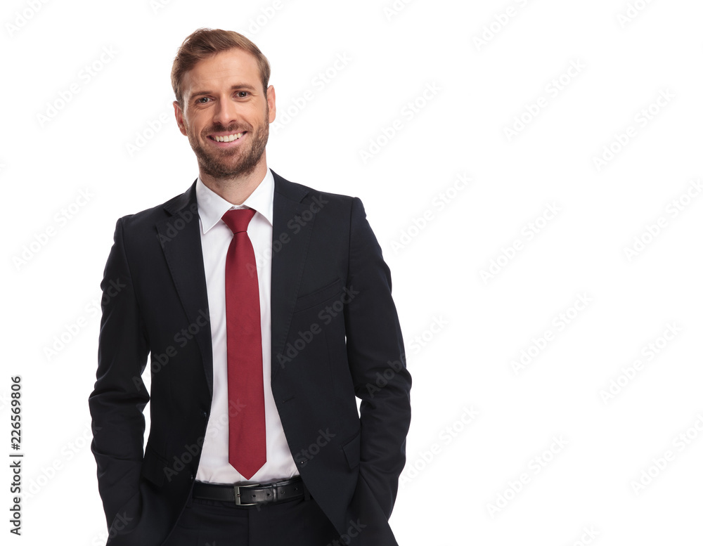 portrait of joyful businessman standing with hands in pockets portrait of joyful businessman standing with hands in pockets