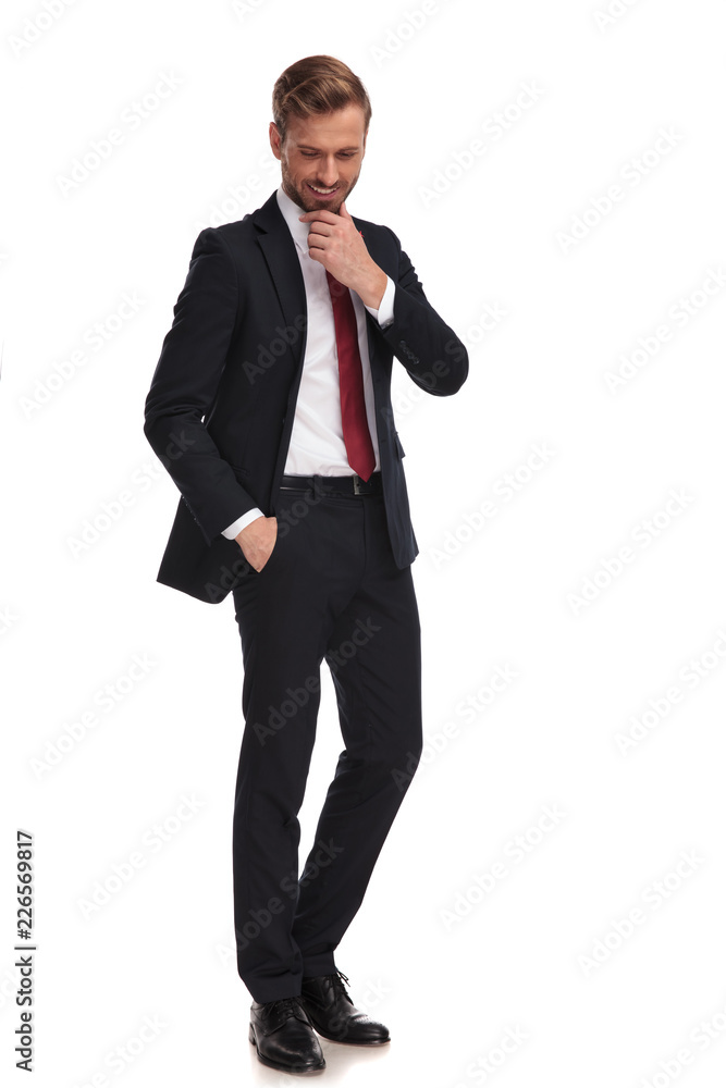 relaxed businessman thinking and looking down while standing relaxed businessman thinking and looking down while standing