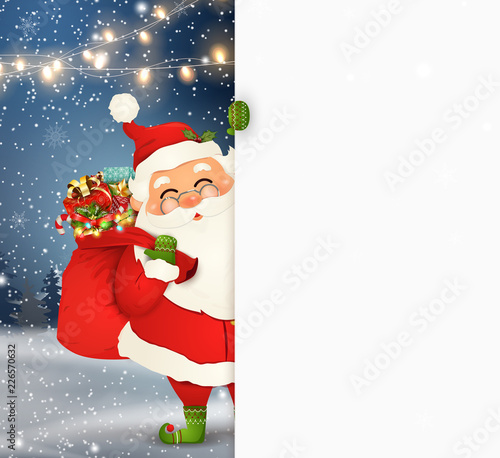 Happy Santa Claus standing behind a blank sign, showing on big blank sign. Cartoon Santa Claus character with gift bag full of gift boxes, white copy space. Holiday winter landscape with firs, snow
