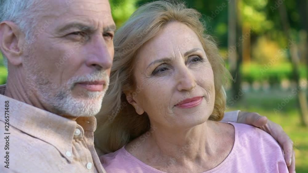 Elder man and woman having rest and happy time together, sitting and hugging Elder man and woman having rest and happy time together, sitting and hugging