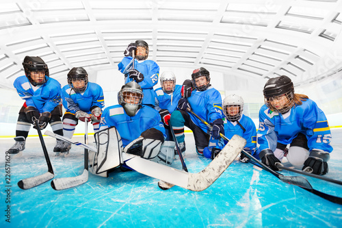 Portrait of children's hockey team at ice arena