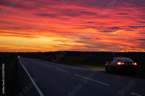 dramatic Beautiful sunset over an expensive car trip around the country