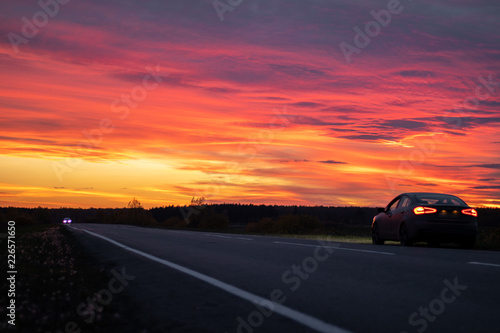 dramatic Beautiful sunset over an expensive car trip around the country