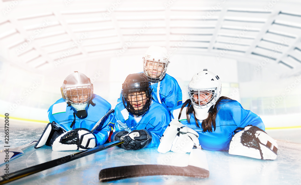 Fototapeta premium Hockey team laying on ice ring after the game