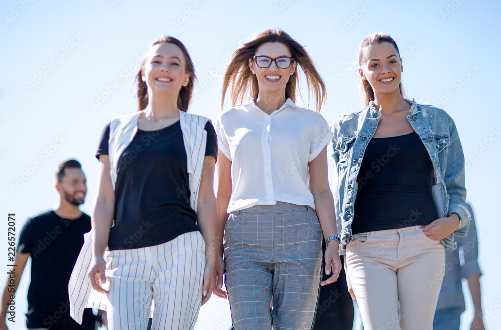 Fototapeta premium group of friends walking together and looking at their future