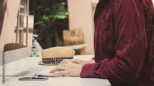 Business man working at office with smart phone at computer